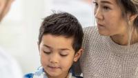 Mother with her child at the doctors office.